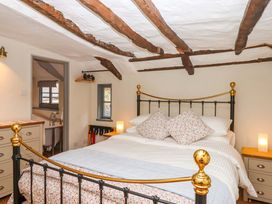 A bedroom with a bed and a window at 1 Myrtle Cottages Stokeinteignhead