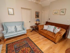 A living room with two sofas and a coffee table at 9 Longhirst Village in Morpeth