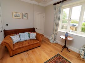 A living room with a couch and side table at 9 Longhirst Village in Morpeth