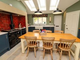 A kitchen with a dining table and chairs at 9 Longhirst Village, Morpeth