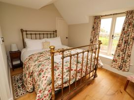 A bedroom with a bed and window at 9 Longhirst Village Morpeth