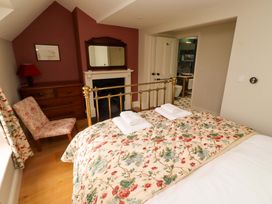 A bedroom with a bed and dresser at 9 Longhirst Village in Morpeth