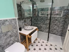 A bathroom with a shower and sink at 9 Longhirst Village in Morpeth