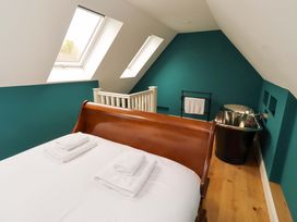 A bedroom with a bed and bathtub at 9 Longhirst Village in Morpeth