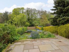 A garden with grass and flowers at 9 Longhirst Village, Morpeth