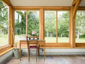 A conservatory with a desk and chair at Henhouse Farm in Bodenham