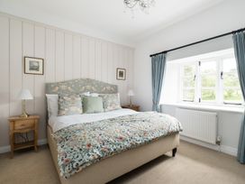 A bedroom with a bed and bedside table at Henhouse Farm in Bodenham