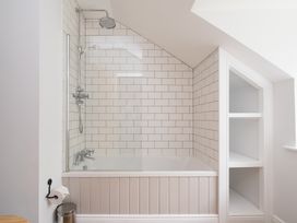 A bathroom with a bathtub and shower at Henhouse Farm in Bodenham