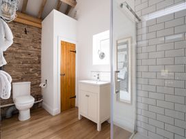 A bathroom with a shower and sink at Henhouse Farm in Bodenham