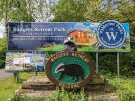 Signs welcoming to Badgers Retreat Park holiday park with a badger emblem and information about homes for sale at The Sanctuary Badgers Retreat Holiday Park near Catterick Garrison North Yorkshire