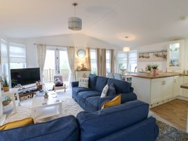 A living room with a sofa and television at The Sanctuary Badgers Retreat Holiday Park near Catterick Garrison, North Yorkshire
