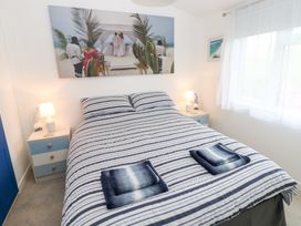 A bedroom with a bed and nightstand at The Sanctuary Badgers Retreat Holiday Park near Catterick Garrison, North Yorkshire