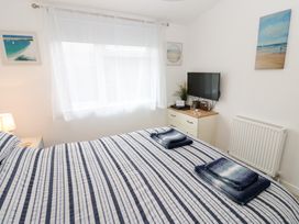 A bedroom with a bed and television at The Sanctuary Badgers Retreat Holiday Park near Catterick Garrison North Yorkshire
