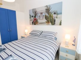 A bedroom with a bed and a wardrobe at The Sanctuary Badgers Retreat Holiday Park near Catterick Garrison, North Yorkshire