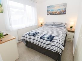 A bedroom with a bed and bedside tables at The Sanctuary Badgers Retreat Holiday Park near Catterick Garrison, North Yorkshire