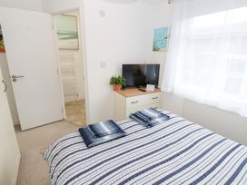 A bedroom with a bed and television at The Sanctuary Badgers Retreat Holiday Park near Catterick Garrison, North Yorkshire