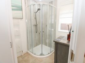 A bathroom with a shower enclosure and a sink at The Sanctuary Badgers Retreat Holiday Park near Catterick Garrison, North Yorkshire