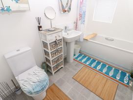 A bathroom with a sink, toilet, and bath tub at The Sanctuary near Badgers Retreat Holiday Park near Catterick Garrison, North Yorkshire