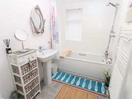 A bathroom with a bath tub and sink at The Sanctuary Badgers Retreat Holiday Park near Catterick Garrison, North Yorkshire