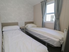 A bedroom with twin beds and a window at Lido Gold 120 Prestatyn