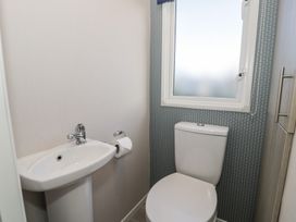 A bathroom with a wash basin and toilet at Lido Gold 120 in Prestatyn