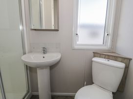 A bathroom with a sink and toilet at Lido Gold 273 in Prestatyn