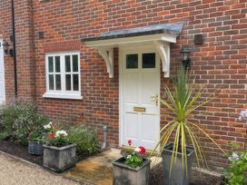 A front door with planters and flowers at Bay Tree Cottage, Peasenhall