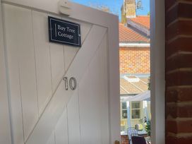 An entrance door with a sign at Bay Tree Cottage, Peasenhall