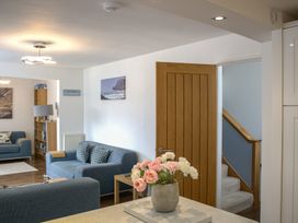 A living room with a sofa and bookshelf at Maceley in Kingsbridge