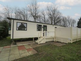 A mobile home with stairs and a patio at Woodlands Gold (WO40) in Ruthin