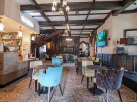 A lobby with a reception desk and seating arrangements at Woodlands Gold in Ruthin