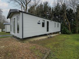 A cabin with windows and steps at Woodlands Gold (WO06) Ruthin
