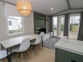 A dining room with a table and chairs at Woodlands Gold (WO06) Ruthin