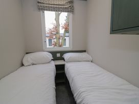 A bedroom with two beds and a window at Woodlands Gold (WO06) Ruthin