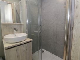 A bathroom with a sink and shower at Woodlands Gold (WO06) Ruthin