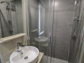 A bathroom with a shower and sink at Woodlands Gold (WO06) in Ruthin