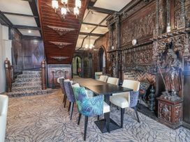 A dining room with a table and chairs at Woodlands Platinum (WO29) Ruthin
