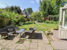 A garden with outdoor furniture on a patio and grass at The Old Coach House in Eglingham near Alnwick