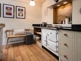 A kitchen with an oven, sink, and bench at The Old Coach House in Eglingham near Alnwick