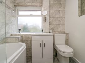 A bathroom with a bathtub sink vanity and toilet at 14 Birchwood Road Woolaston