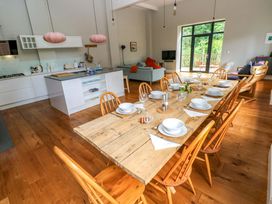 A kitchen with a dining table and chairs at The Old Creamery in Ffairfach
