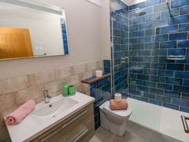 A bathroom with a shower, sink, and toilet at The Old Creamery in Ffairfach