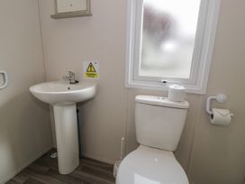 A bathroom featuring a sink and toilet at Gold Caravan (316) Talybont