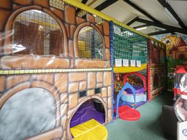 An indoor play area with colorful play structure and soft play equipment at Gold Caravan (316) Talybont