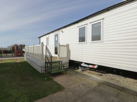 A caravan with steps and railing in an outdoor area at Gold Caravan (203) Talybont
