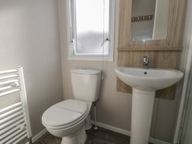 A bathroom with a sink and toilet at Gold Caravan (203) Talybont