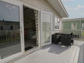 An outdoor area with a table and chairs at Gold Lodge (201) Talybont