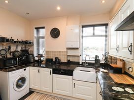 A kitchen with appliances and cabinets at Falcon's Nest in Whitby
