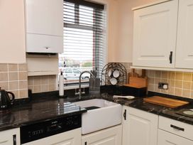 A kitchen with sink and cabinets at Falcon's Nest in Whitby