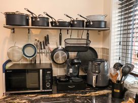 A kitchen with pots and kitchen appliances at Falcon's Nest in Whitby